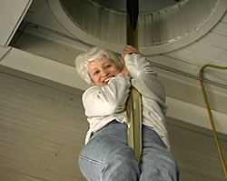 Etta sliding down a firehouse pole