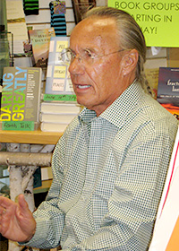 Lourey signing books