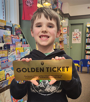 child holding golden ticket