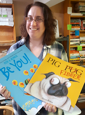 Jen holding books that should be read aloud!
