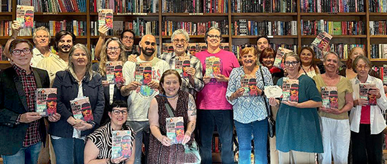 Smiling people holding the book