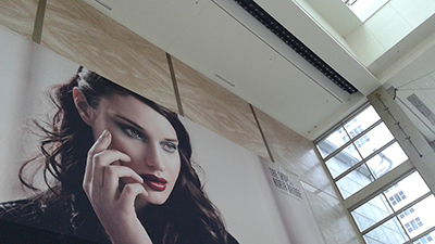 Billboard sized face but on floor by doors
