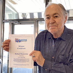 Richard Hamersma holding certificate of award